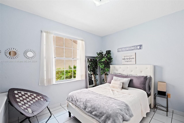 bedroom featuring baseboards and light tile patterned floors