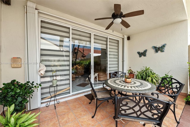 view of patio with outdoor dining space and a ceiling fan