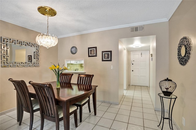 tiled dining room with a textured ceiling, an inviting chandelier, and ornamental molding