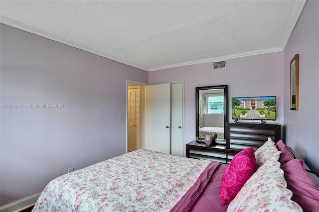 bedroom with a textured ceiling and ornamental molding