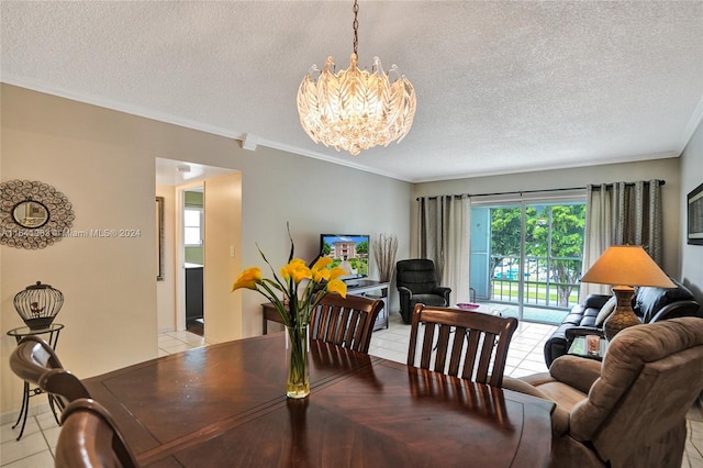 tiled dining area featuring crown molding, a textured ceiling, and a chandelier