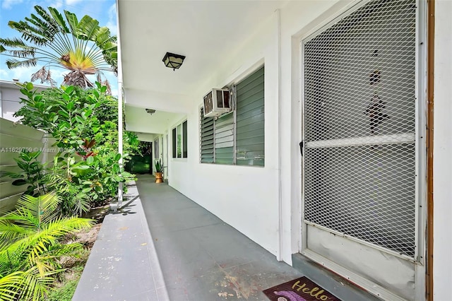 exterior space with a wall mounted air conditioner