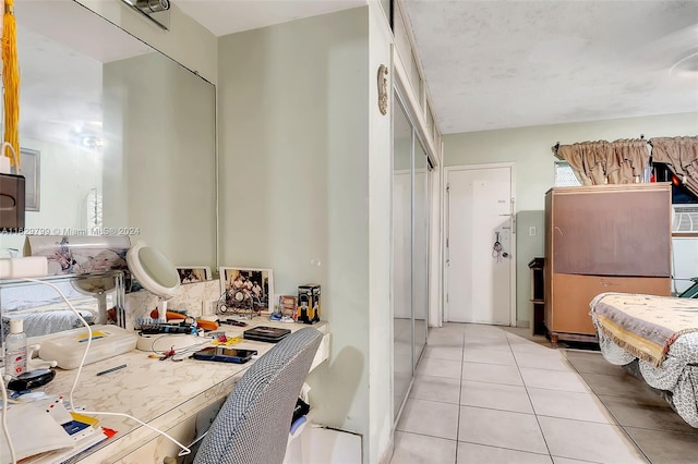 interior space with a closet and light tile patterned floors