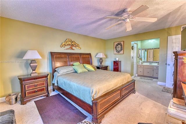 carpeted bedroom featuring a textured ceiling, ceiling fan, and ensuite bathroom