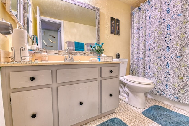 bathroom featuring vanity, toilet, and tile patterned flooring