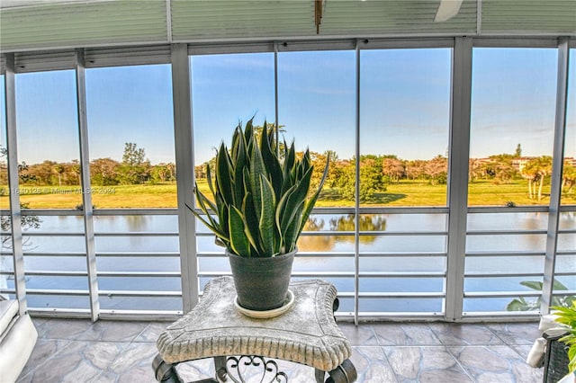 unfurnished sunroom with a water view