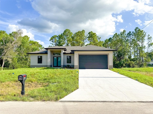 view of front of house with a garage and a front lawn