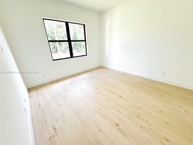 spare room with light hardwood / wood-style flooring