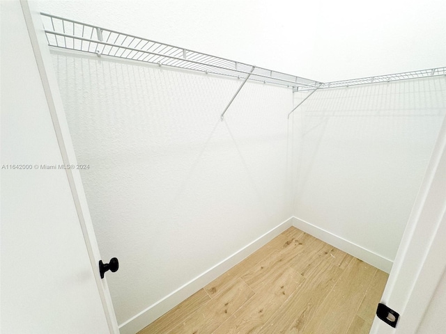 walk in closet featuring hardwood / wood-style flooring