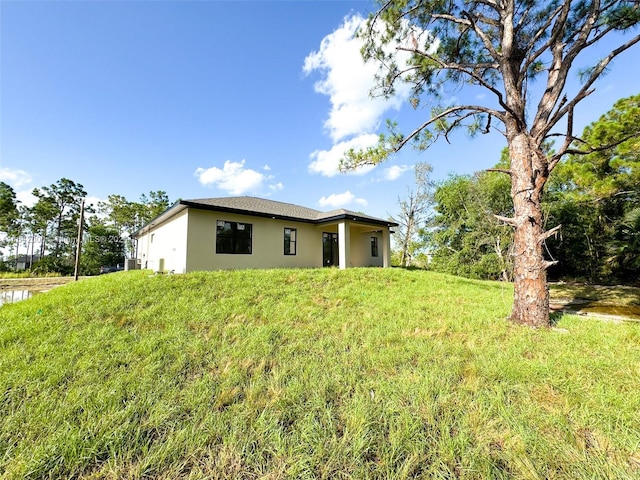 rear view of house featuring a lawn