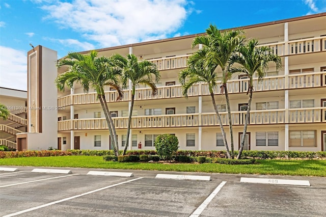 view of building exterior with uncovered parking