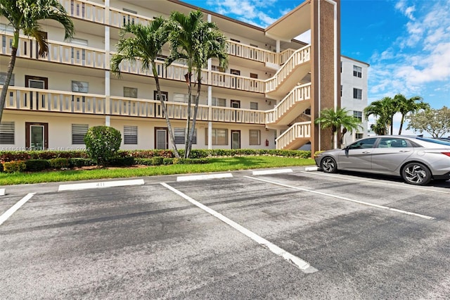 view of building exterior with uncovered parking