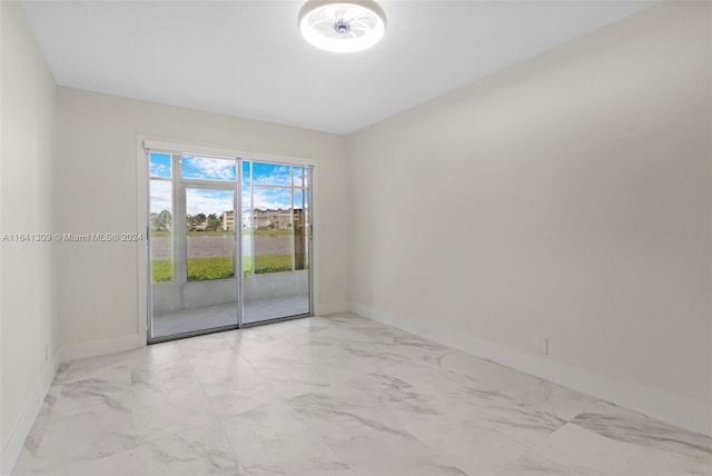 spare room featuring light tile patterned floors