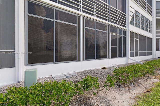 view of property exterior featuring a sunroom