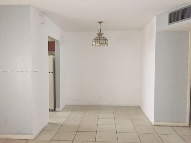 hall featuring light tile patterned floors