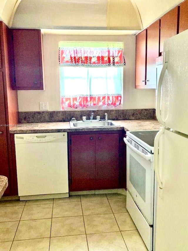 kitchen with sink, light tile patterned flooring, and white appliances