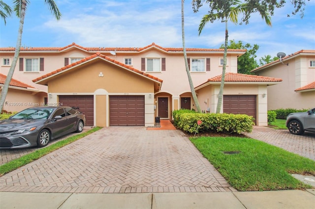 mediterranean / spanish-style home with a garage