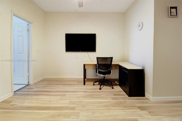 home office with ceiling fan and light hardwood / wood-style floors