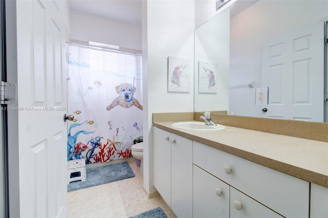 bathroom with tile patterned flooring, toilet, walk in shower, and vanity