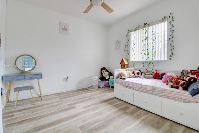 bedroom with light hardwood / wood-style floors and ceiling fan