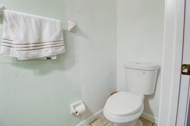 bathroom with tile patterned flooring and toilet