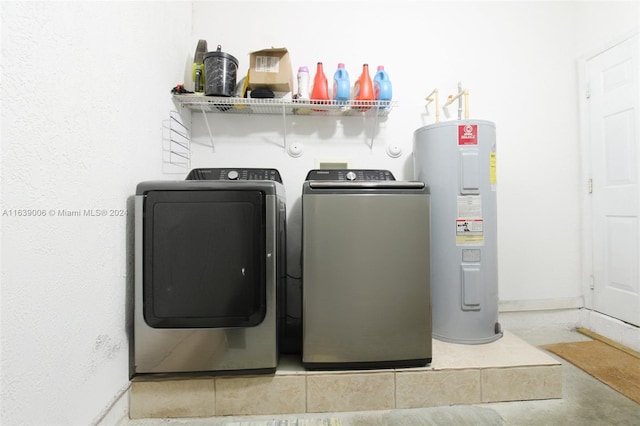 clothes washing area with washer and dryer and water heater