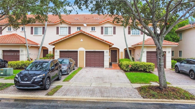 mediterranean / spanish-style house with a garage