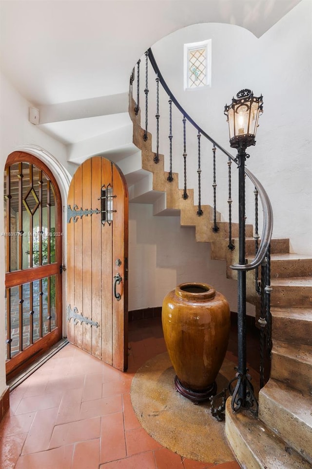 stairway with tile patterned floors