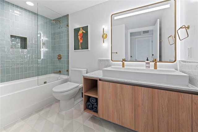 full bathroom featuring tiled shower / bath combo, toilet, tile patterned floors, and vanity