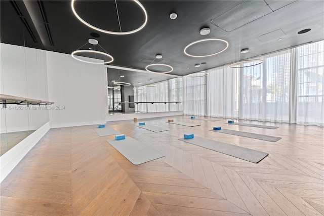 workout area featuring parquet flooring