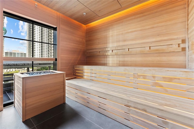 view of sauna / steam room with wooden ceiling and wood walls