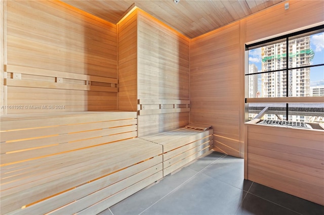 view of sauna featuring wooden walls and wood ceiling