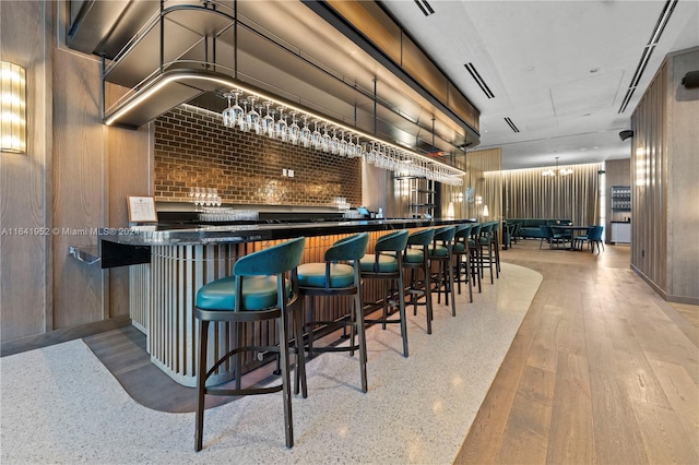 bar featuring light hardwood / wood-style floors