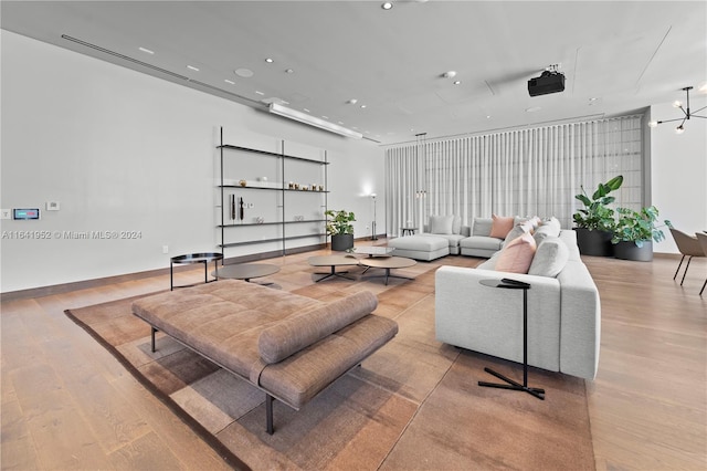 living room featuring light hardwood / wood-style flooring and a chandelier