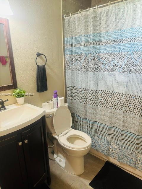 bathroom with tile patterned floors, vanity, and toilet