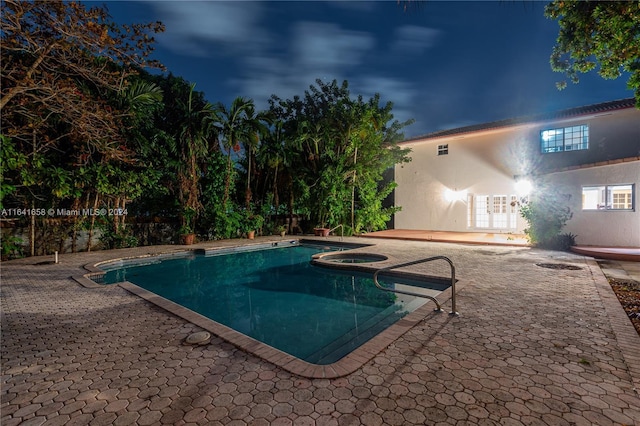 view of pool with an in ground hot tub and a patio