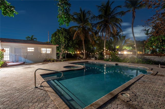 view of pool with an in ground hot tub and a patio area