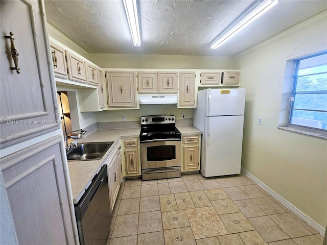 kitchen featuring dishwasher, light tile patterned floors, white fridge, stainless steel range with electric cooktop, and sink