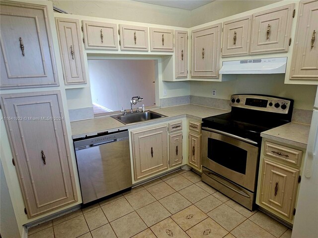 4025 N Nob Hill Rd Unit 507, Sunrise, FL 33351 - kitchen featuring light countertops, exhaust hood, light tile patterned flooring, appliances with stainless steel finishes, and a sink