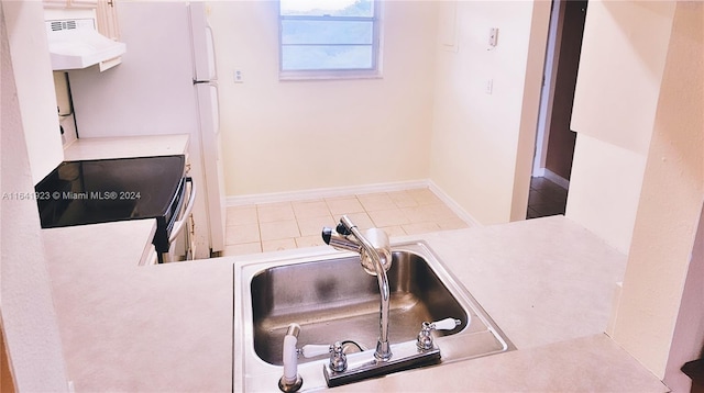 4025 N Nob Hill Rd Unit 507, Sunrise, FL 33351 - interior details with baseboards, black / electric stove, light countertops, a sink, and ventilation hood