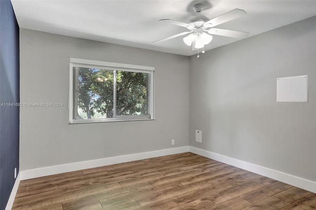 empty room with ceiling fan and hardwood / wood-style floors