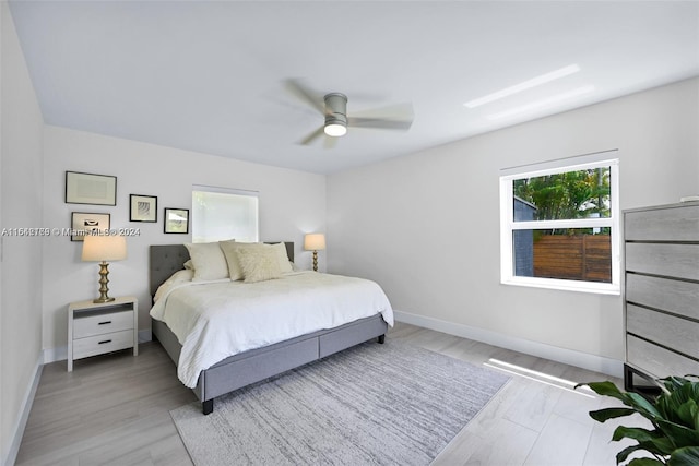 bedroom with ceiling fan and light hardwood / wood-style flooring