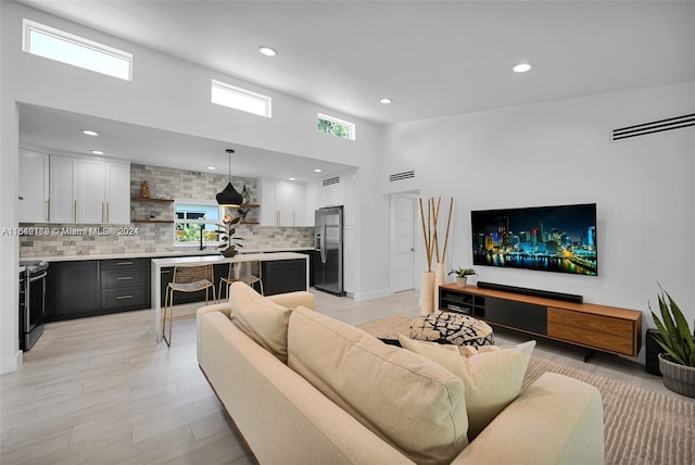 living room featuring a high ceiling