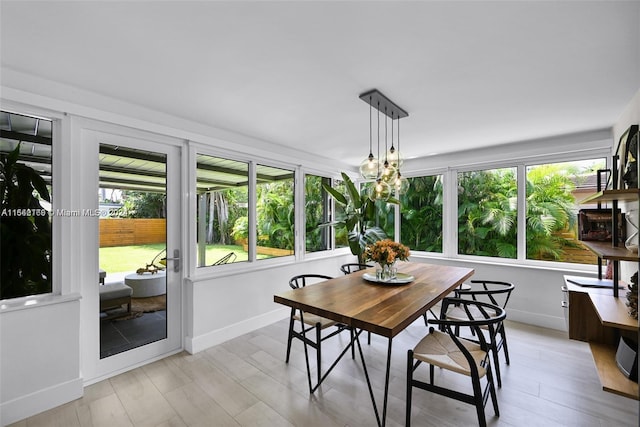 dining area with light hardwood / wood-style floors and a wealth of natural light