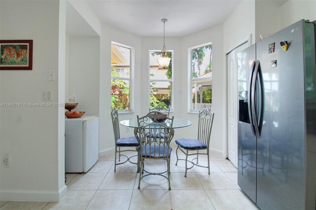 kitchen featuring sink, appliances with stainless steel finishes, hanging light fixtures, light stone countertops, and white cabinets