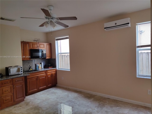 kitchen with tasteful backsplash, an AC wall unit, visible vents, a ceiling fan, and black microwave