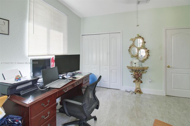 office space with baseboards and visible vents