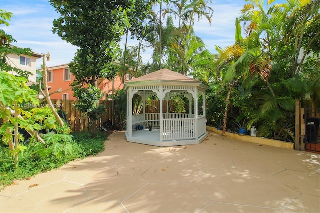 view of community featuring a gazebo, fence, and a patio