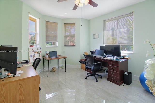 office featuring ceiling fan and baseboards