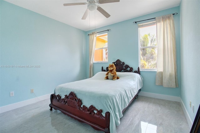 bedroom featuring a ceiling fan and baseboards